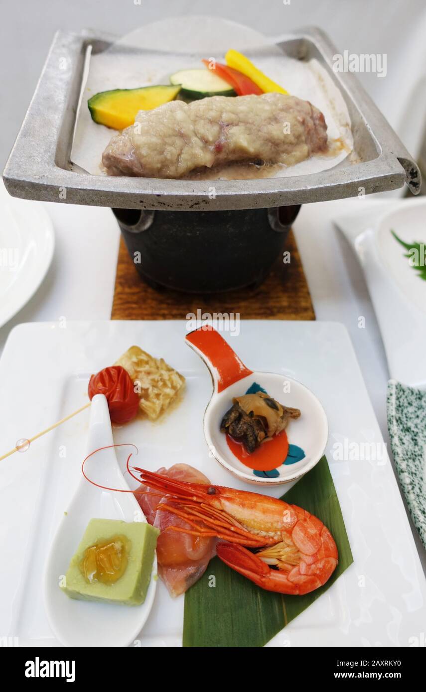 Kaiseki is a traditional multi-course Japanese dinner prepared by a chef with select seasonal ingredients. Stock Photo