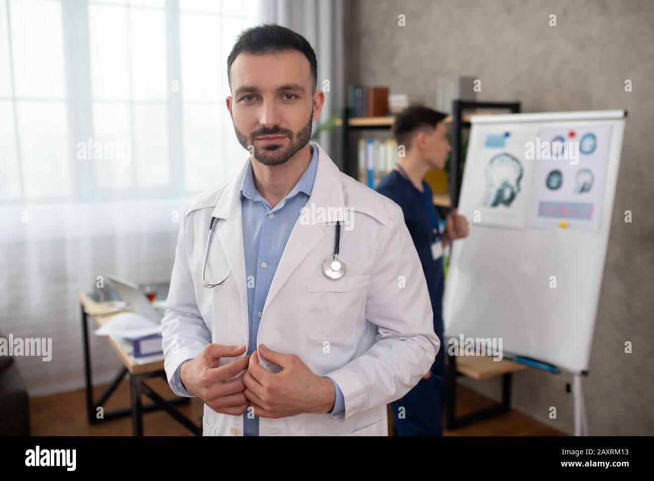 Dark haired young doctor hi-res stock photography and images - Alamy