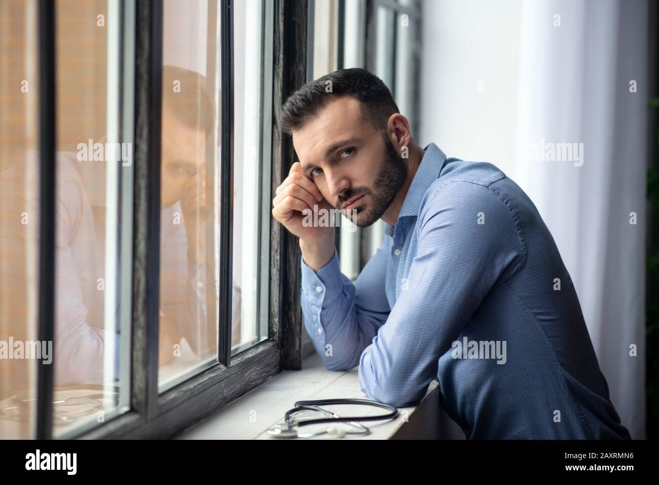 Upset young bearded man doctor hi-res stock photography and images - Alamy
