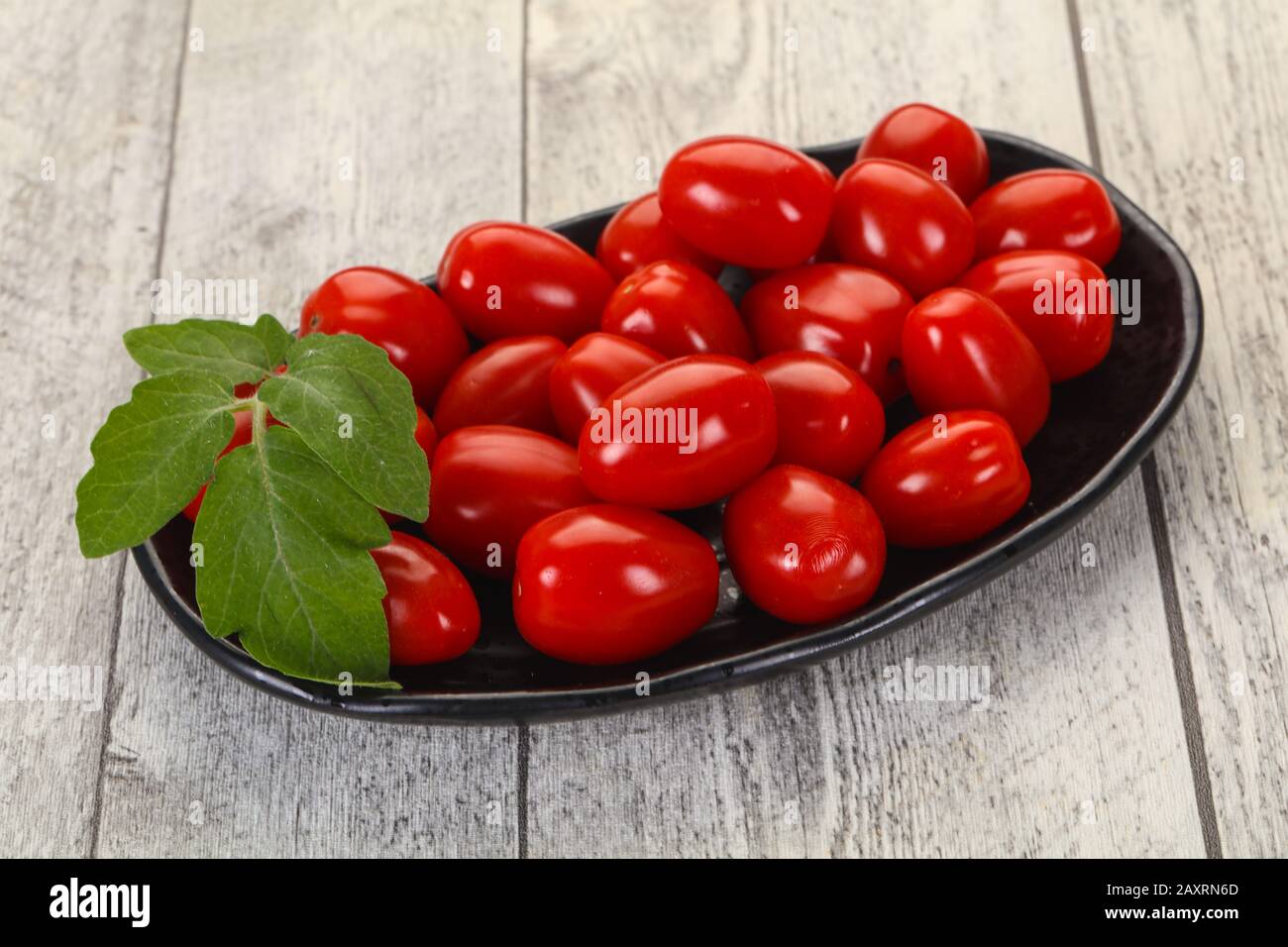 Sweet Red cherry tomatoes in the bowl Stock Photo - Alamy