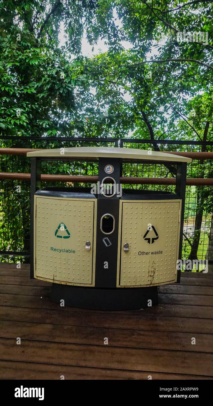 A modern trash can in a downtown park in Jakarta, Indonesia Stock Photo