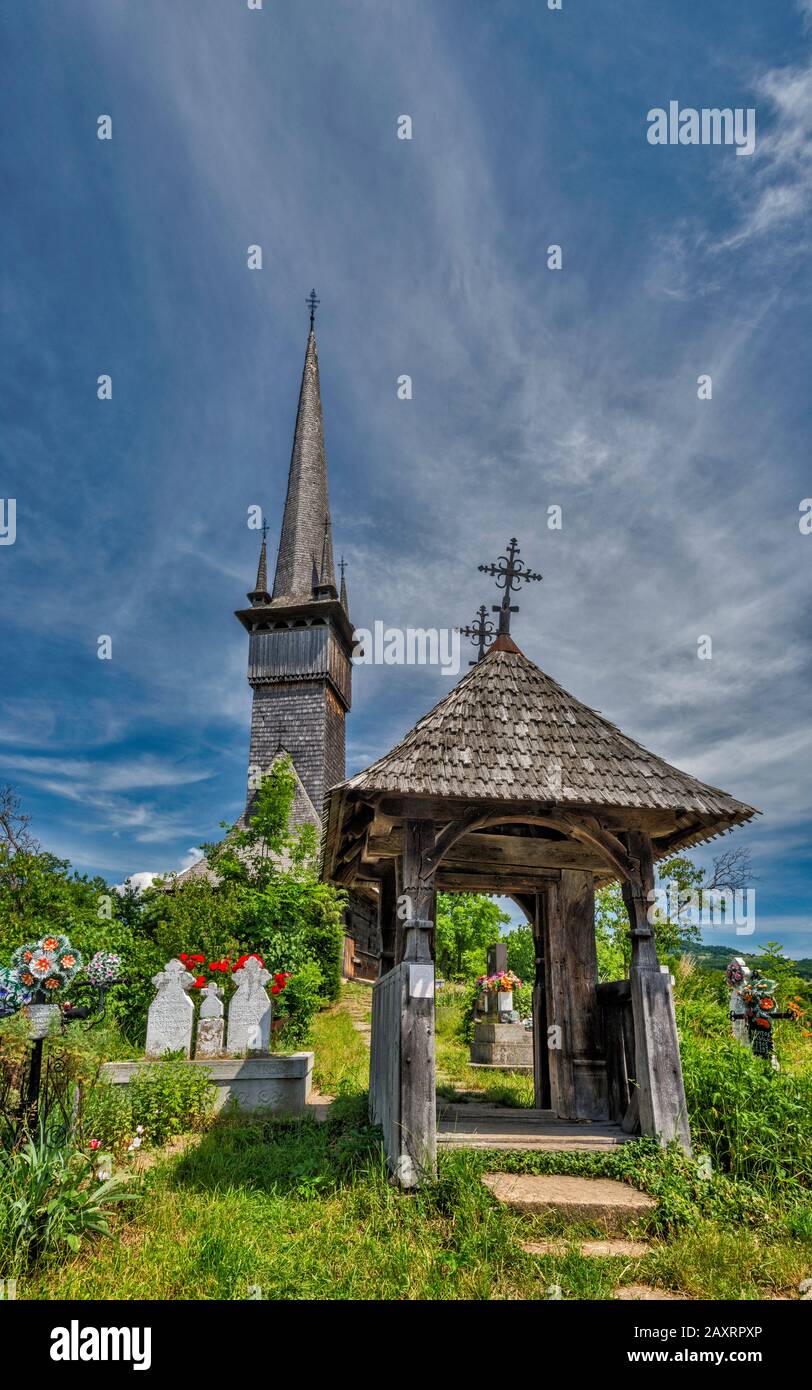 Gate to cemetery and Church of Archangels Michael and Gabriel, wooden Romanian Orthodox Church, built 1798, in village of Plopis, Maramures, Romania Stock Photo