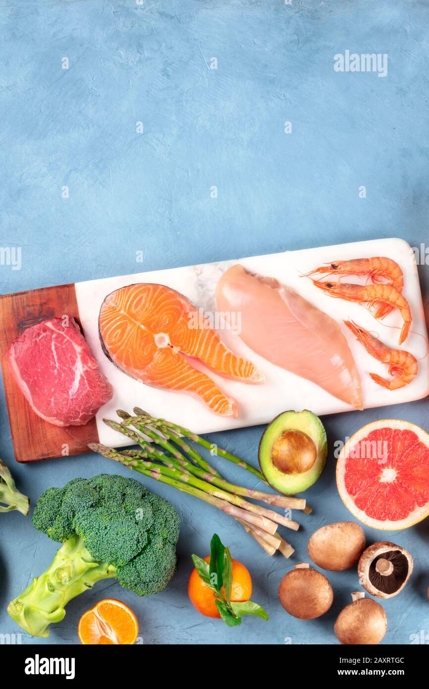 Food overhead flat lay shot. Main proteins, meat, fish, poultry and seafood, with vegetables and fruit, shot from the top with a place for text Stock Photo