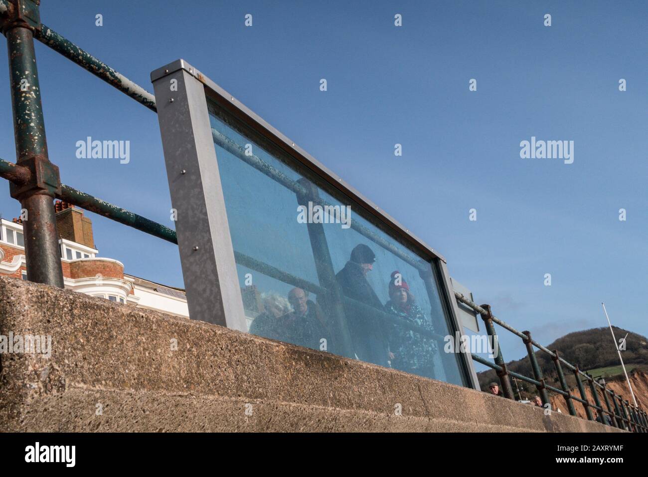 Glass sea defence panels installed on test on the sea wall at Sidmouth, Devon, withstood the full battering of storm Ciara. Stock Photo
