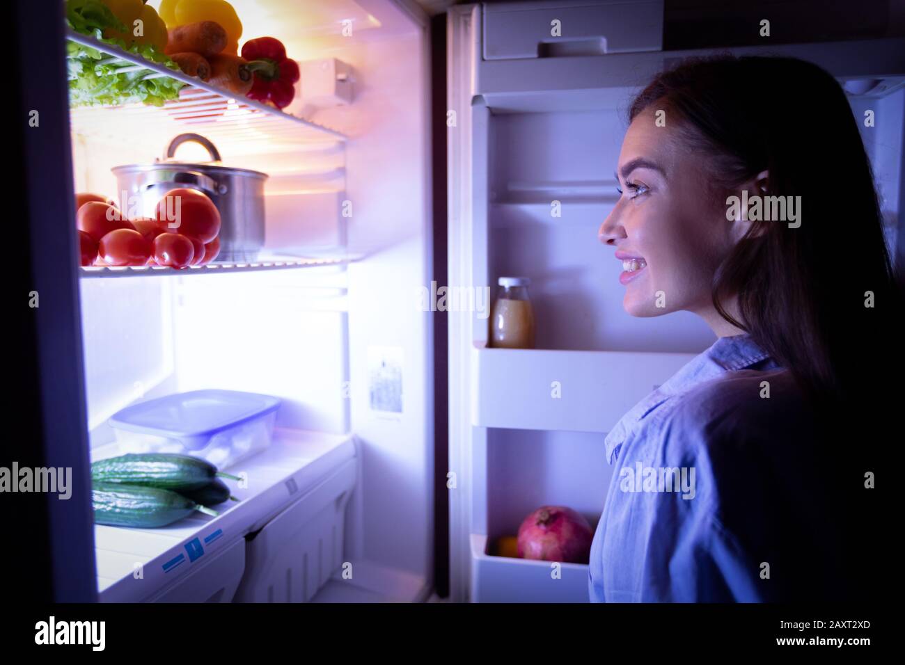 Millennial woman raiding refrigerator late at night Stock Photo - Alamy