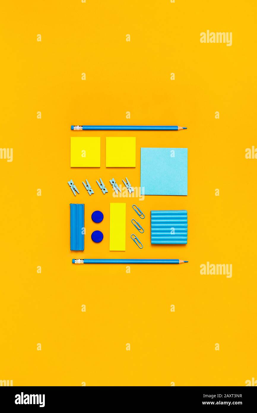 Yellow background with yellow and blue writing materials for school and