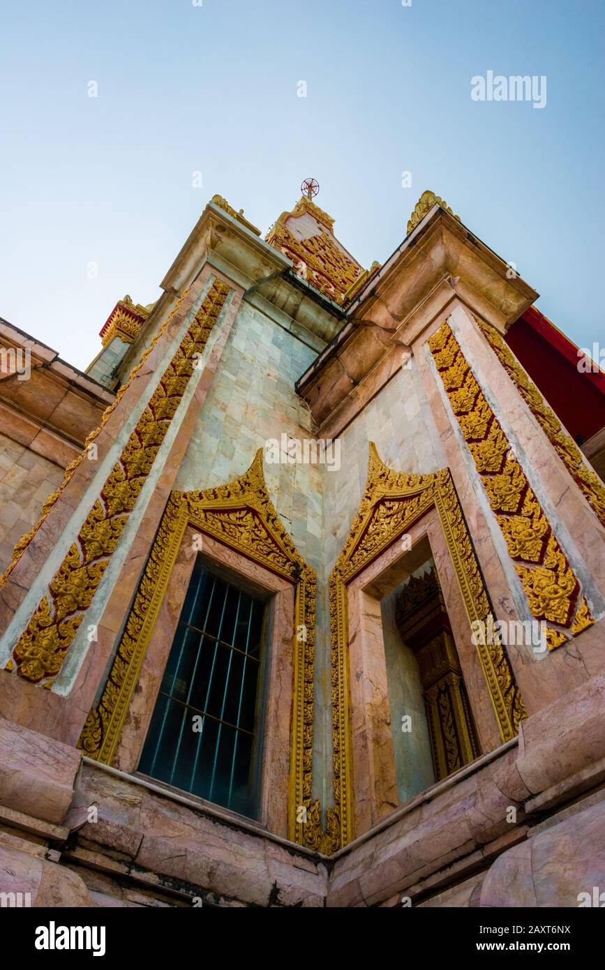 Wat Chalong,Phuket/Thailand-15December2019: view on a pagoda at the historical landmark and Buddhist temple with blue sky and sunny day Stock Photo