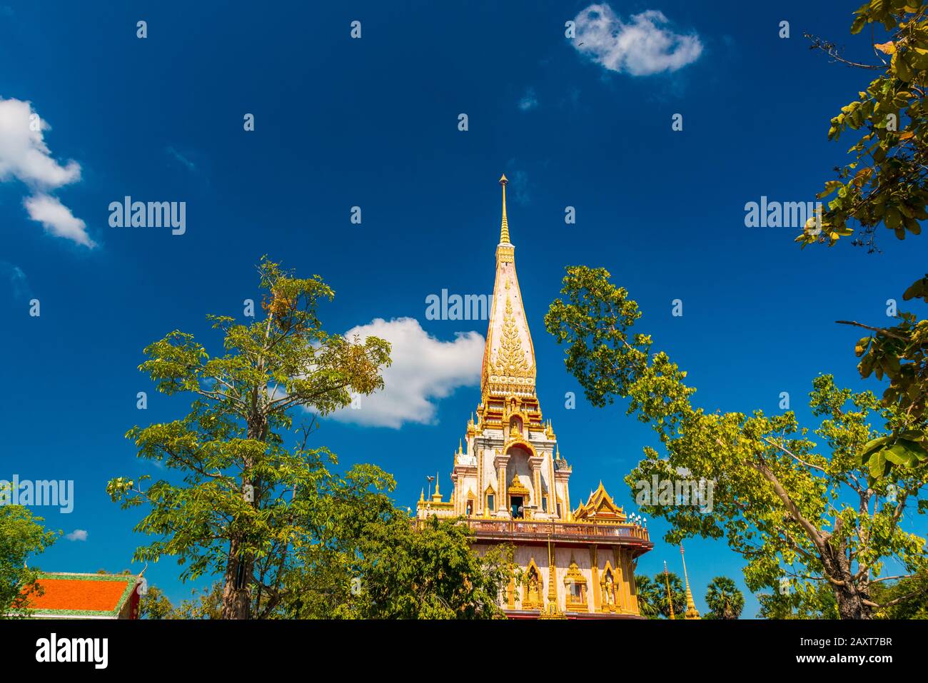 Wat Chalong,Phuket/Thailand-15December2019: view on a pagoda at the historical landmark and Buddhist temple with blue sky and sunny day Stock Photo