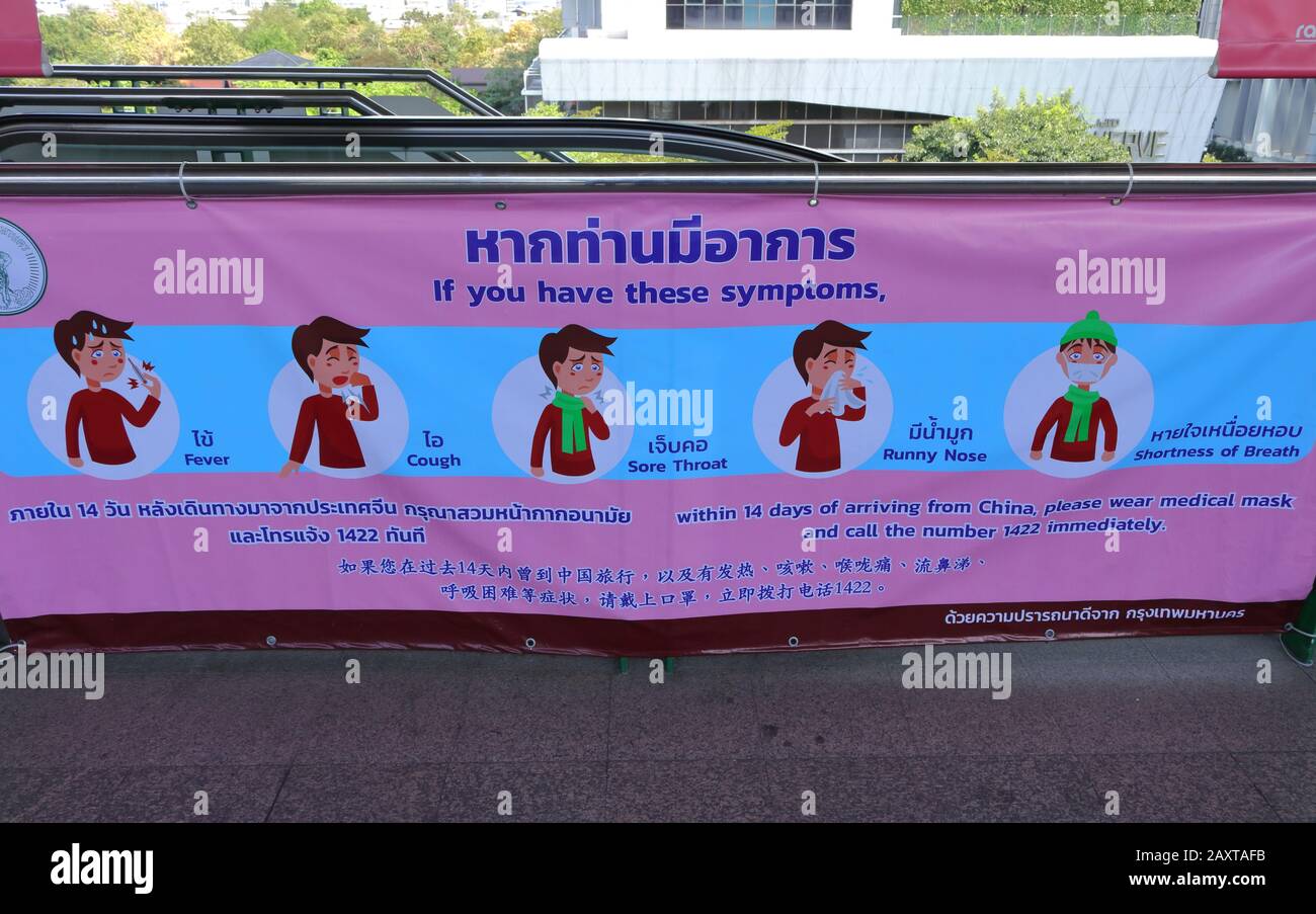 Bangkok, Thailand- February 13 2020: Vinyl warning sign about coronavirus 2019 or covid 19 hanging on guard rail at skytrain station Stock Photo