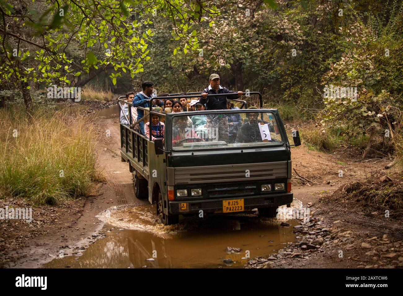 India, Rajasthan, Ranthambhore, National Park, Zone 2, Canter truck full of Indian tourists on afternoon safari Stock Photo