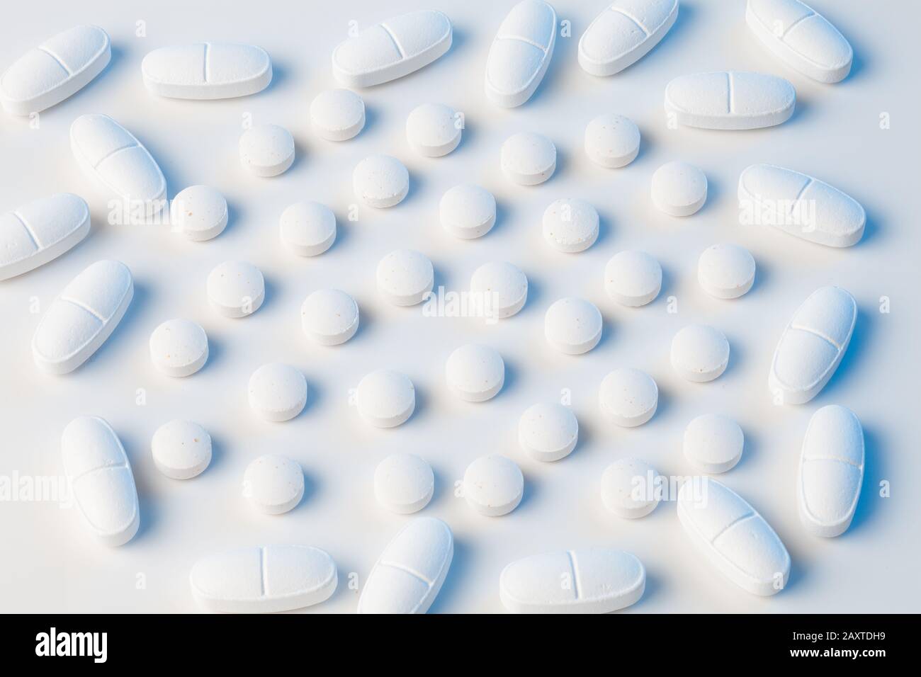 white pills on white background with blue lights Stock Photo