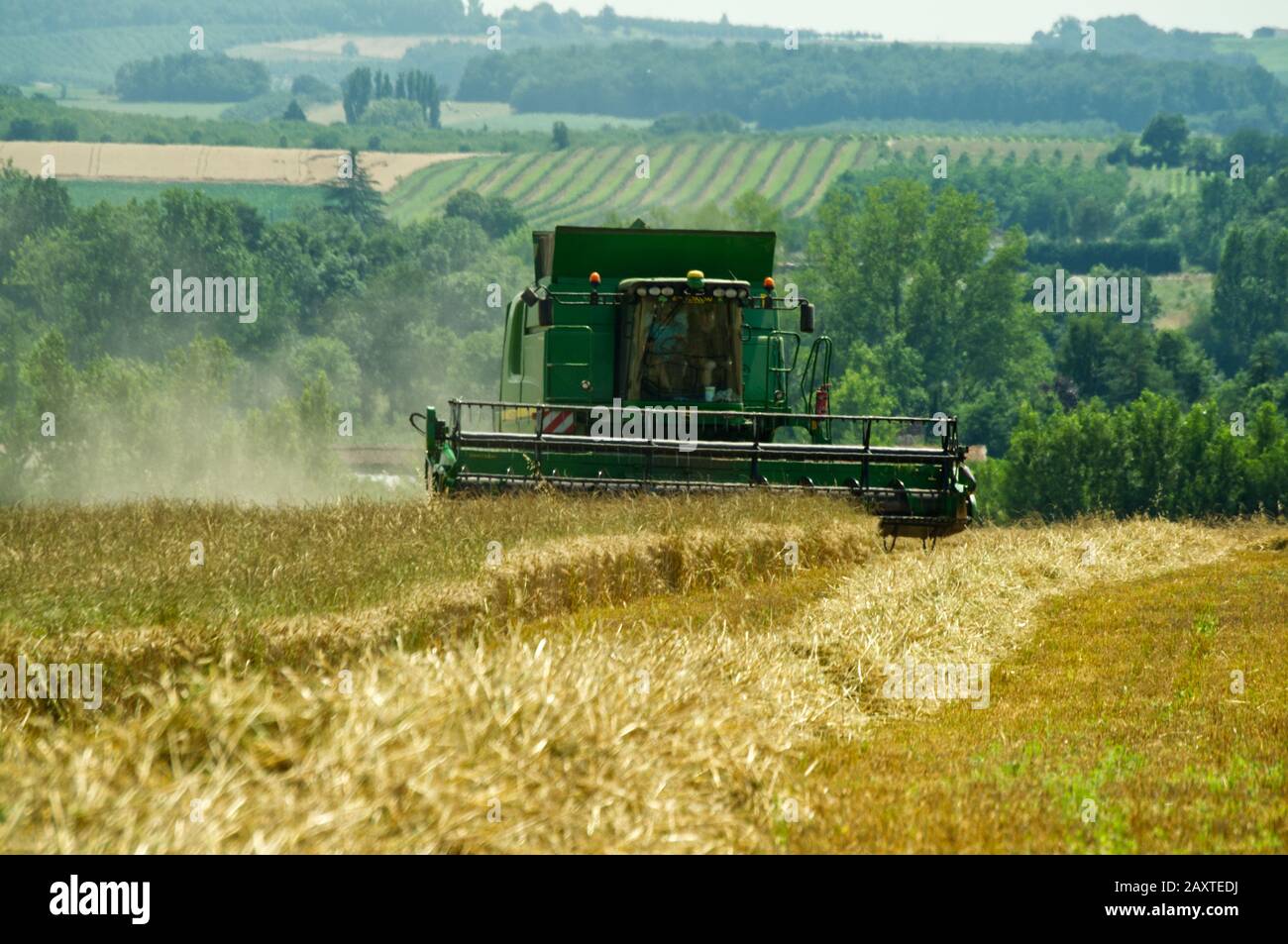 Harvesting wheat near Duras, Lot-et-Garonne, France with a John Deere T670 Hillmaster combine harvester. Stock Photo