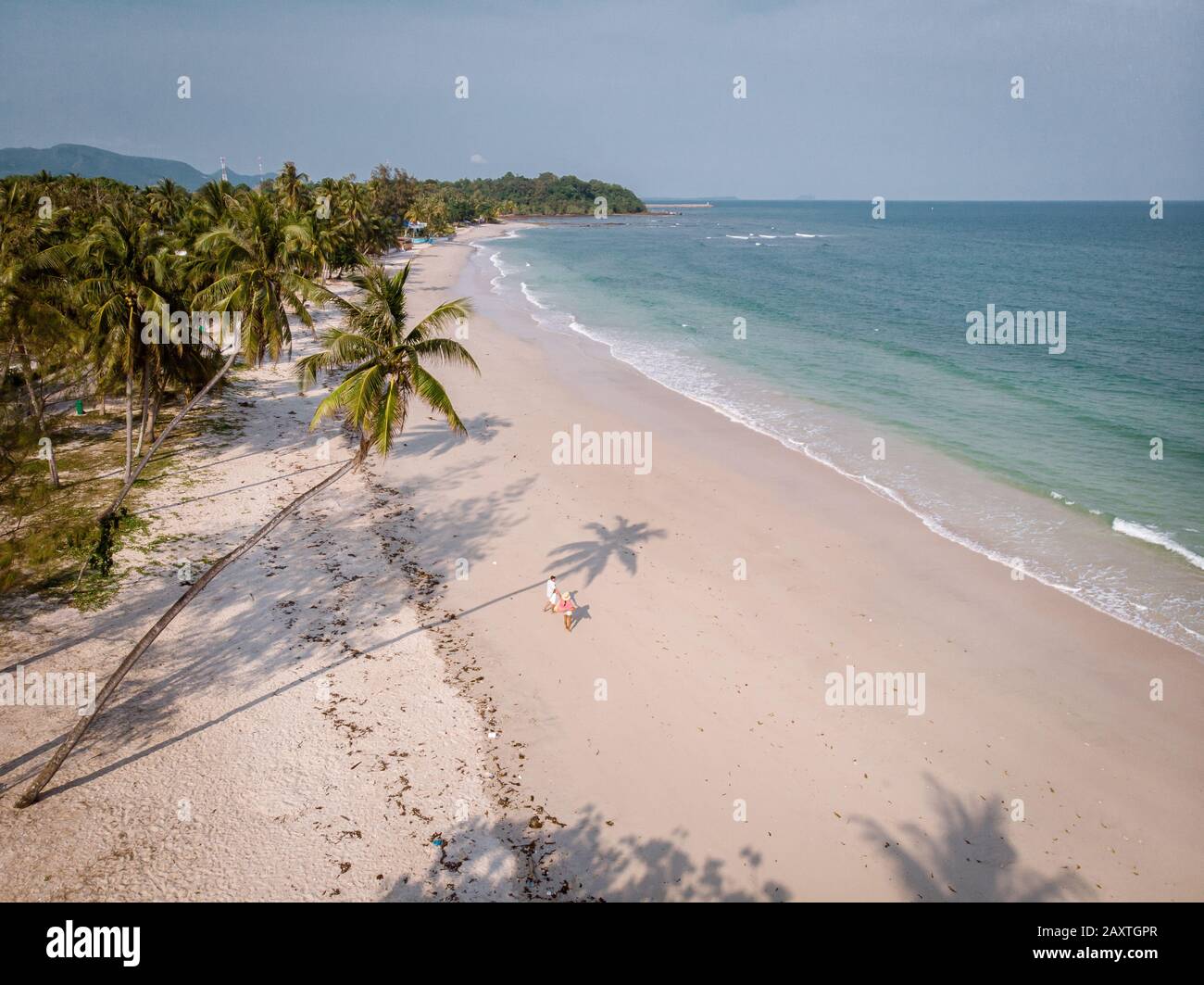 Hat Thun Wua Laen beach in Chumphon area Thailand, drone view from above at the beach with white sand and palm trees, couple walking on the white Stock Photo
