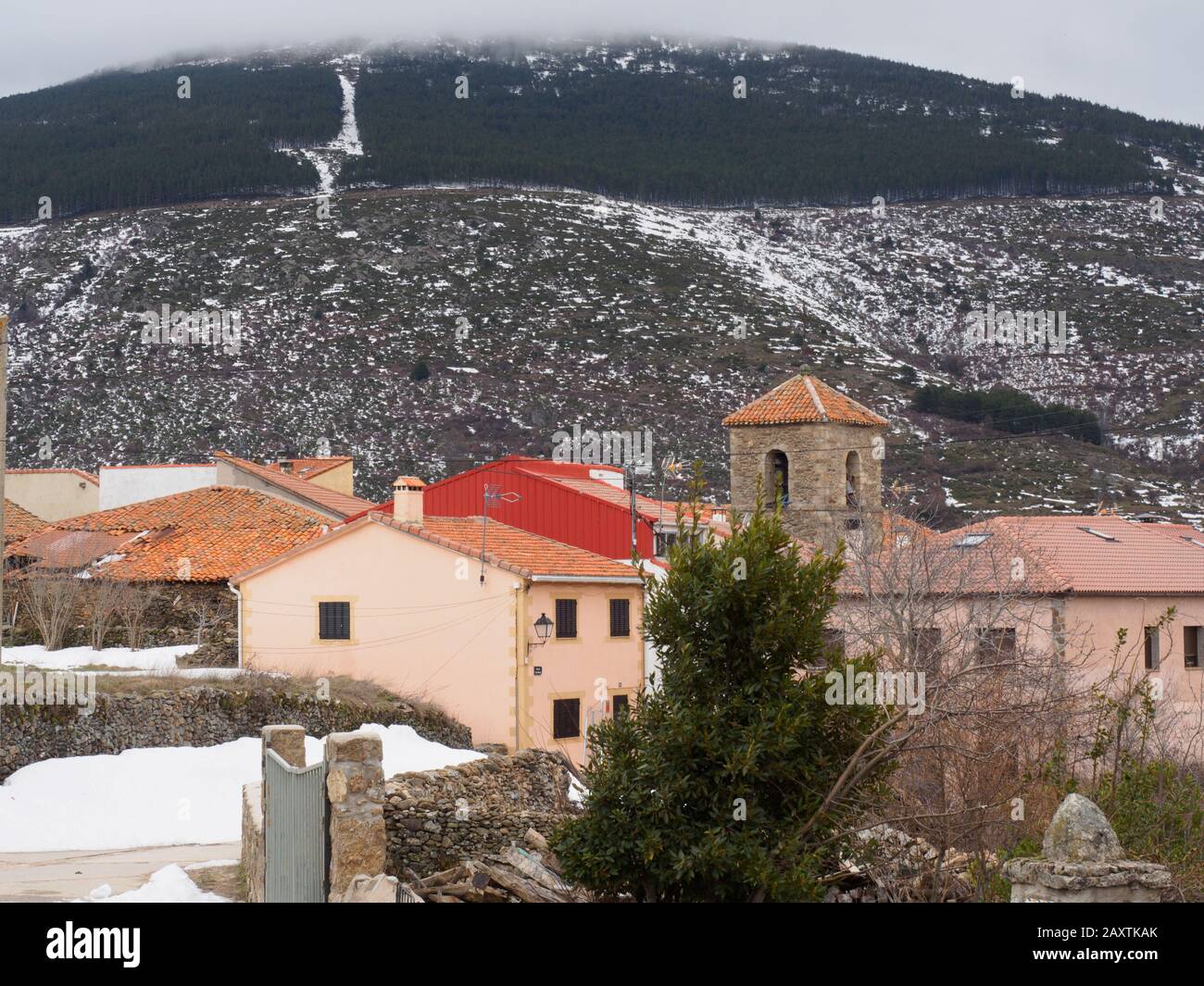 Small village in the mountains with winter snow Stock Photo