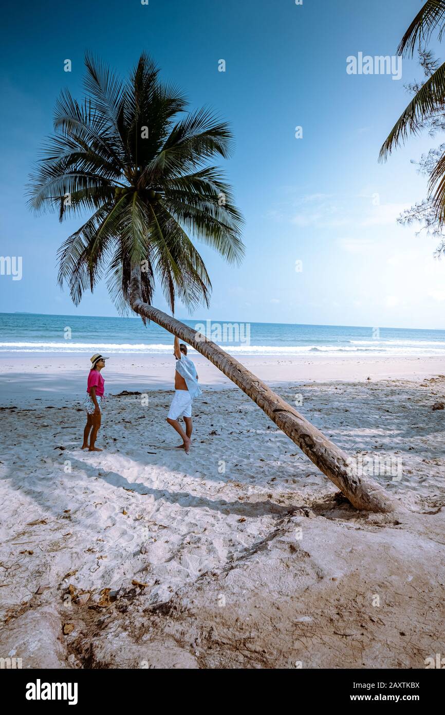 Wua Laen beach Chumphon area Thailand, palm tree hanging over the beach with couple on vacation in Thailand Stock Photo