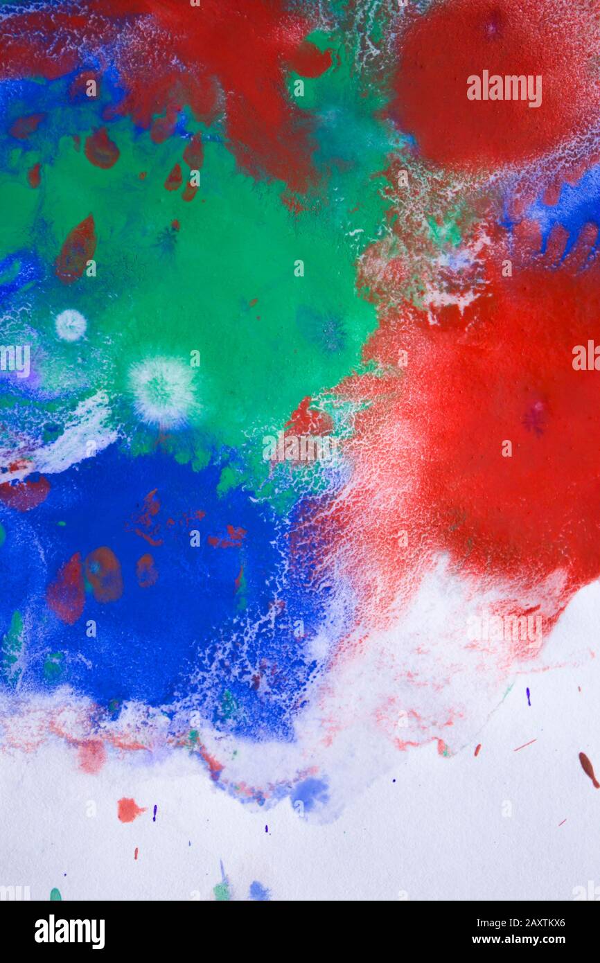 red, blue, green ink droplet spreads on paper Stock Photo Alamy