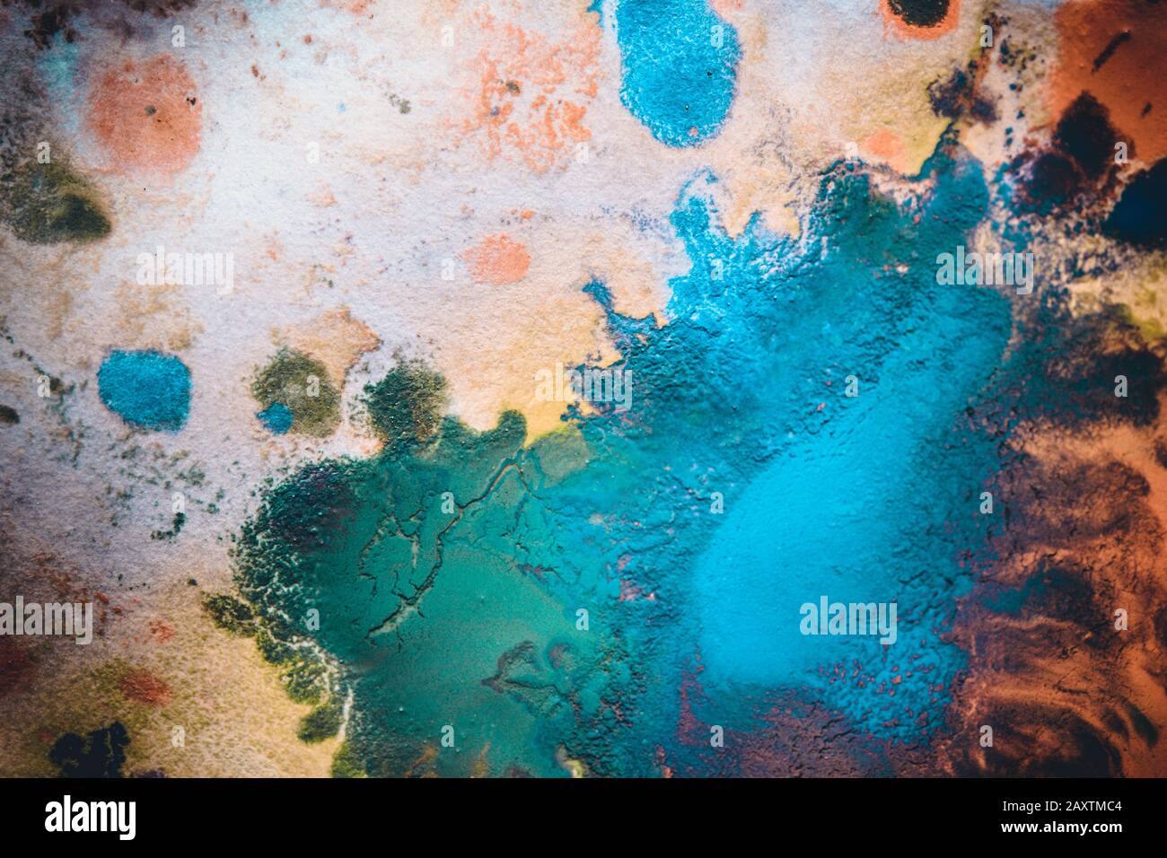 Multicolored paint stains, drips, splashes, mixing. Abstract background Stock Photo
