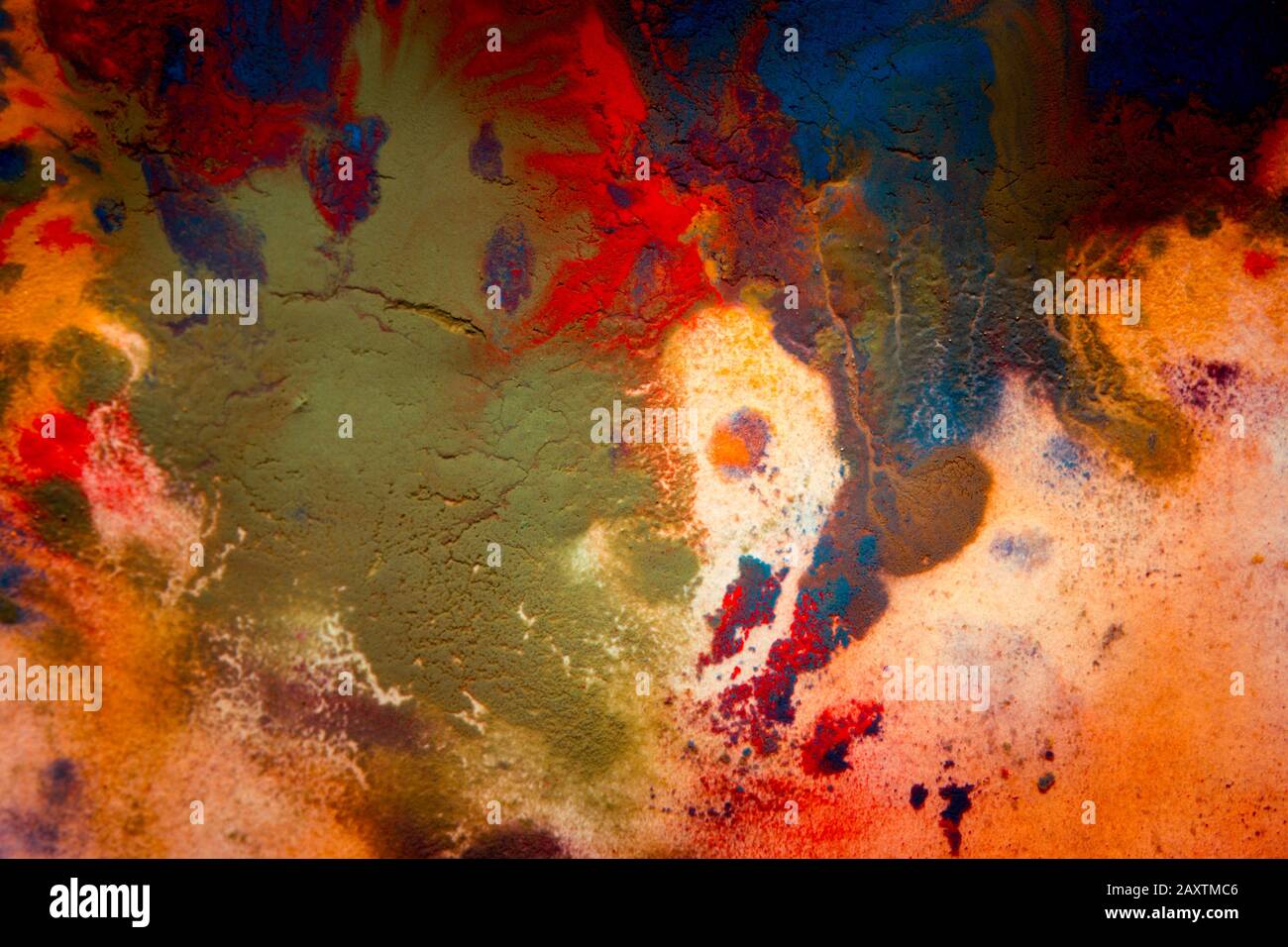 Multicolored paint stains, drips, splashes, mixing. Abstract background Stock Photo