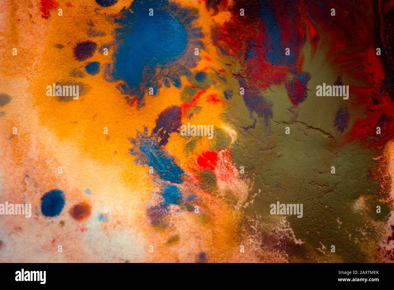 Multicolored paint stains, drips, splashes, mixing. Abstract background Stock Photo