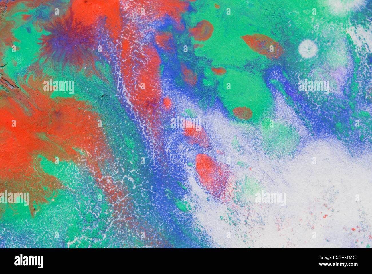Multicolored paint stains, drips, splashes, mixing. Abstract background Stock Photo