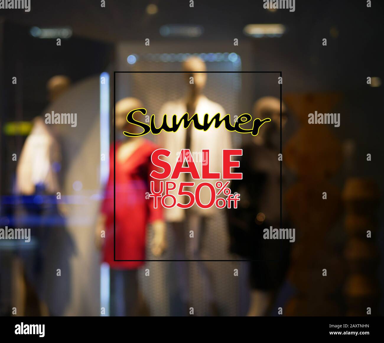 sign summer sale discount 50 percent with blurry display of a clothing store showroom at background. summer sale season or clearance marketing promote Stock Photo