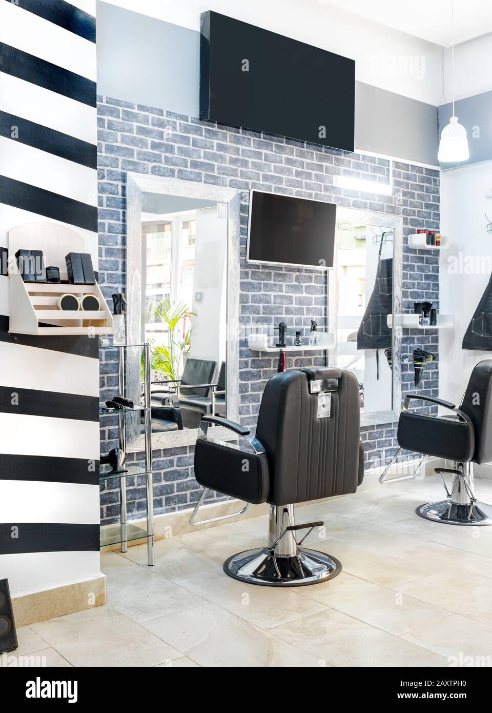 Modern bright beauty salon. Hair salon interior business with industrial  minimal look. Black and white decoration with mirrors, chairs,tv screen and  m Stock Photo - Alamy
