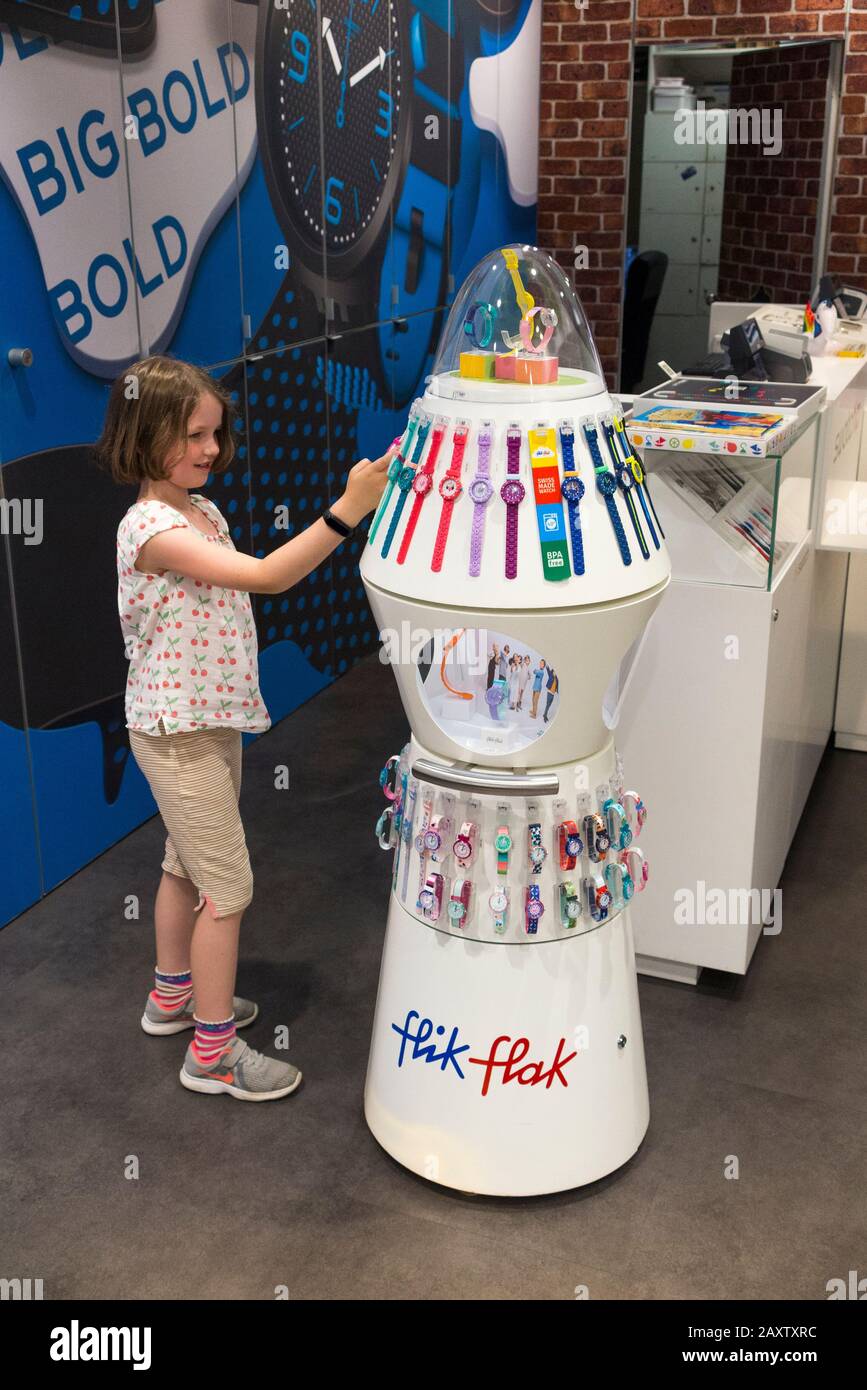 Child / children / kid / kids peruse and examine / look at watches made by  Swatch in the Swatch watch shop of Geneva airport in Switzerland. (112  Stock Photo - Alamy