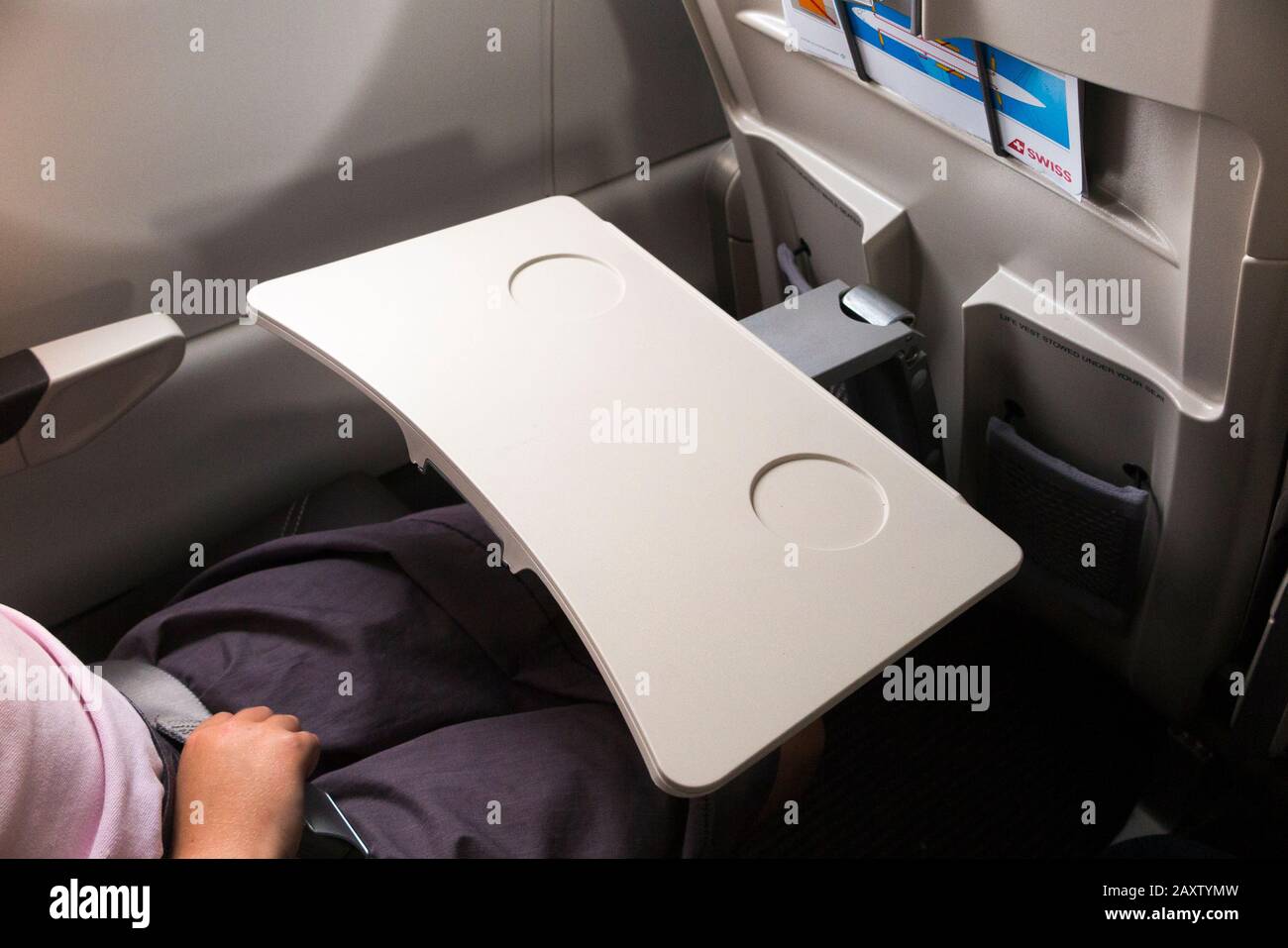 Passenger seat tray table in the full down position ready for use, on a