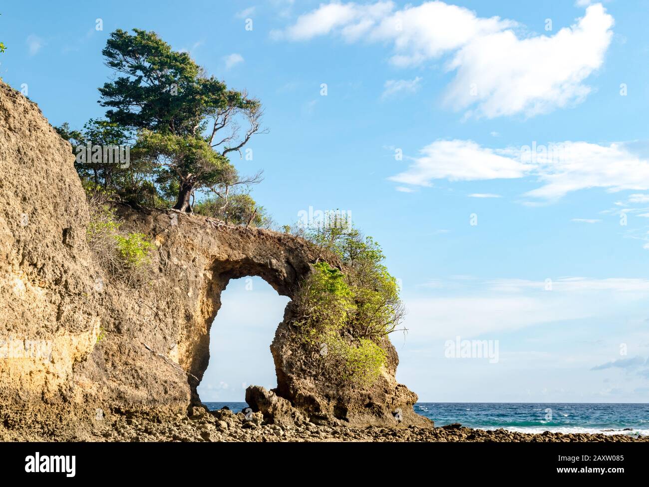 Geological formation of Rock Arch at Neil island, looks like natural bridge or a natural gate, formed off constant erosion; with calm sea and blue sky Stock Photo