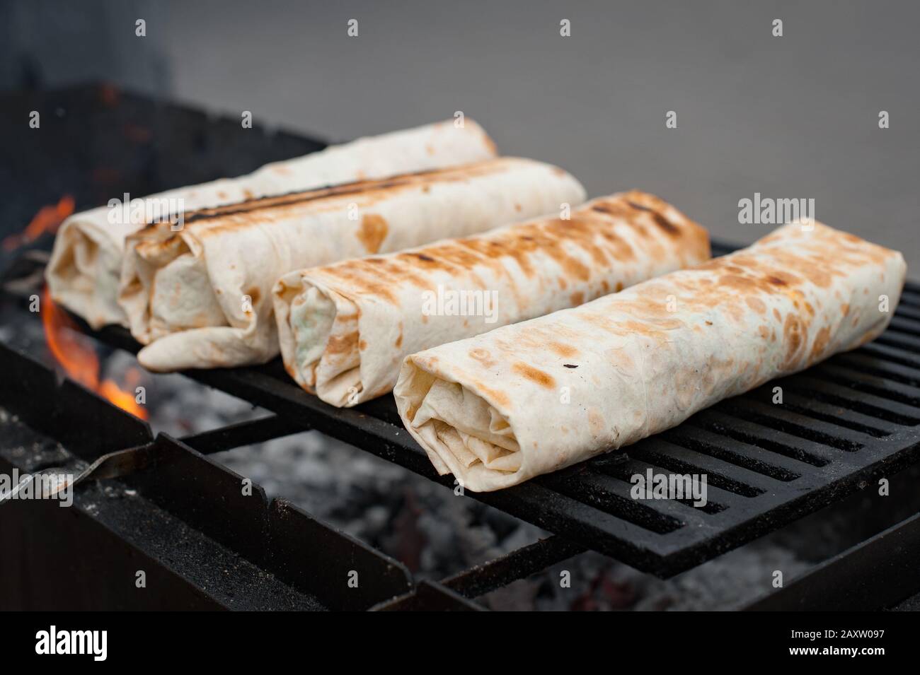 Preparation of shawarma on the grill. Street food.Grilled lavash rolls.  Shawarma Stock Photo - Alamy