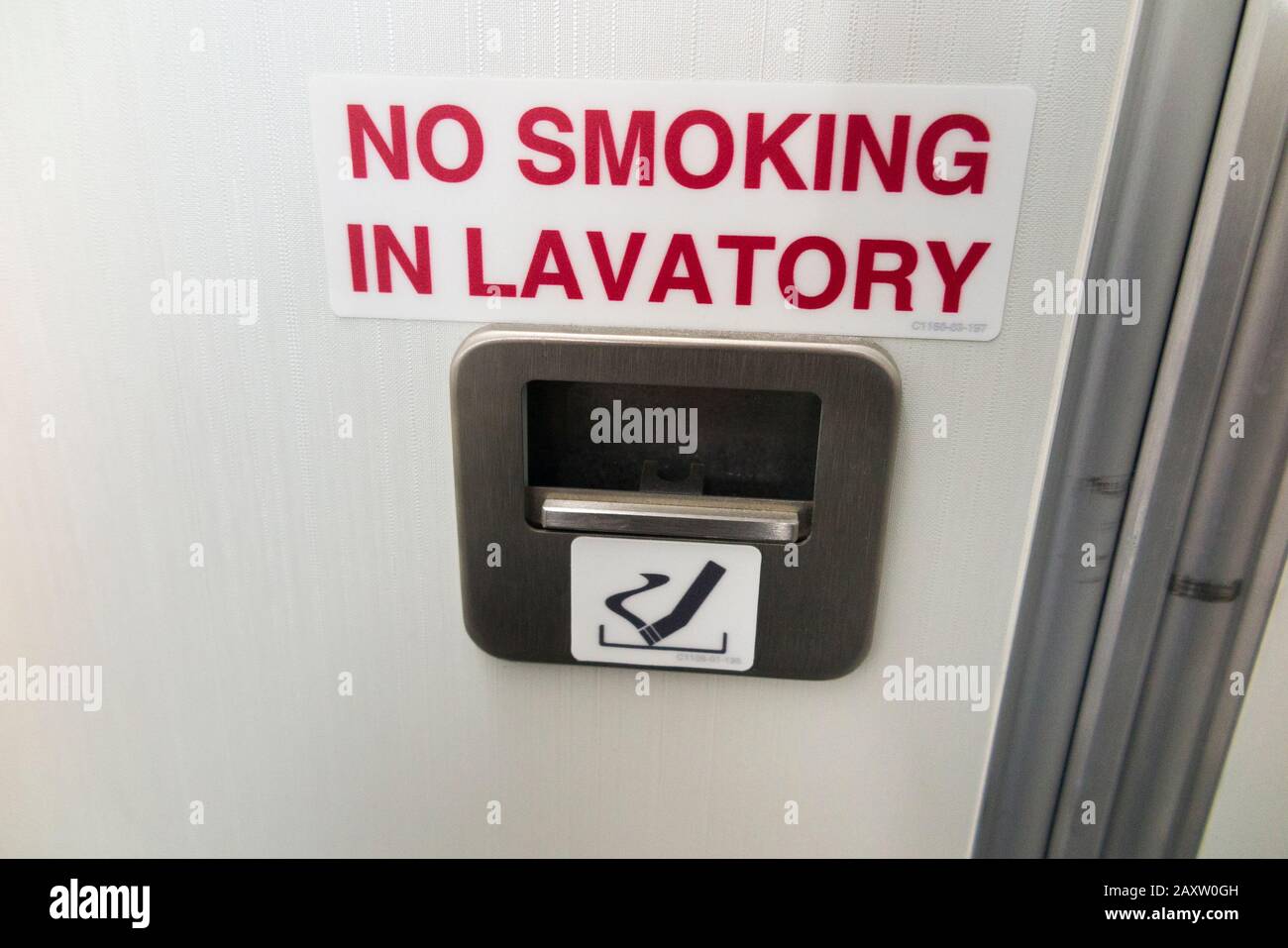 Ash tray / ashtray and No Smoking sign in toilet / loo / lavatory / WC in a Bombardier C series plane / aeroplane / airplane (An aircraft now marketed UK as an Airbus A220). (112) Stock Photo