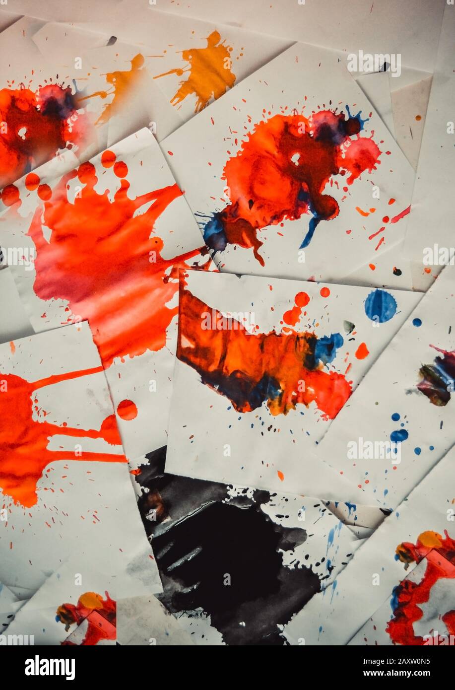 Many red colored blots on white paper with streaks. Abstract creative spots of paint on a white background. Red bright colors. Stained-spattered table Stock Photo