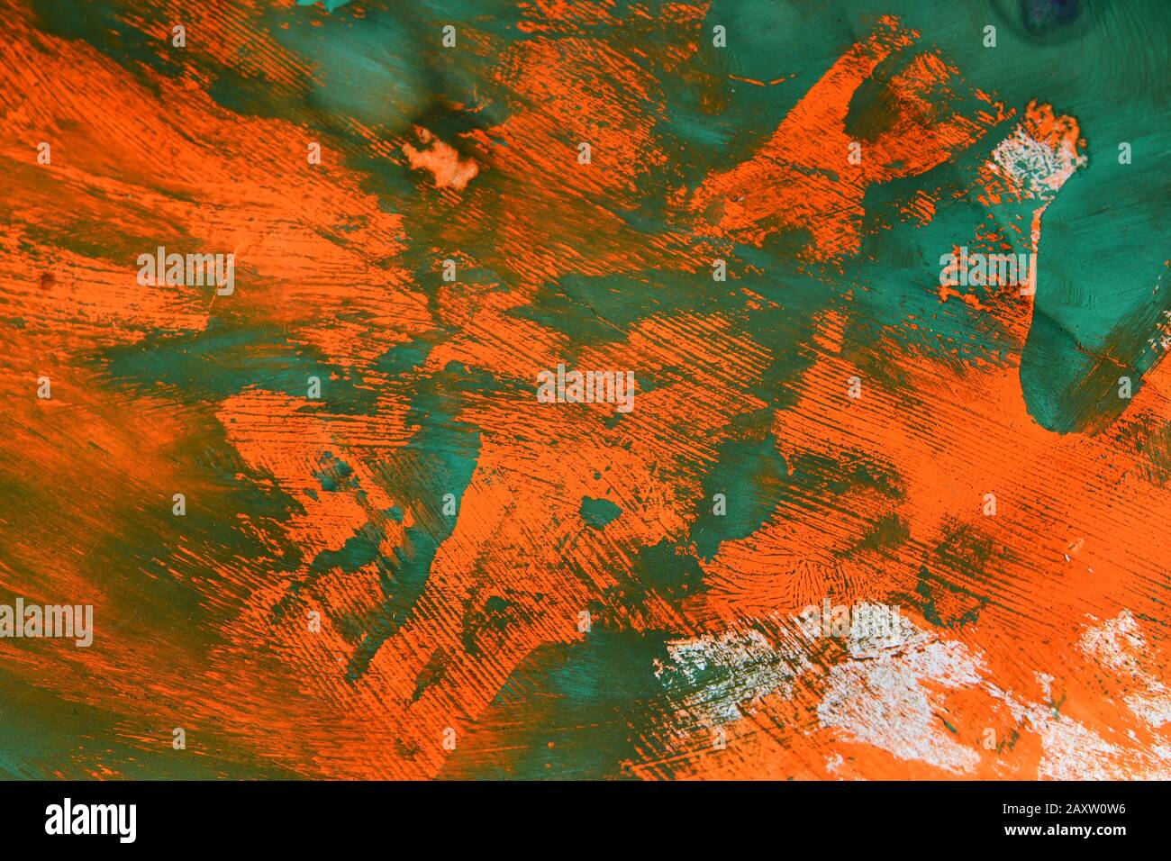 Abstract background of smears of green over orange paint Stock Photo