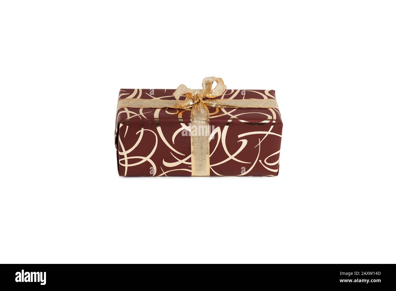 packaged rectangular gift in dark brown packaging with gold bow and gold pattern on a white background Stock Photo