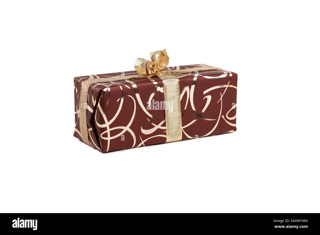 packaged rectangular gift in dark brown packaging with gold bow and gold pattern on a white background Stock Photo