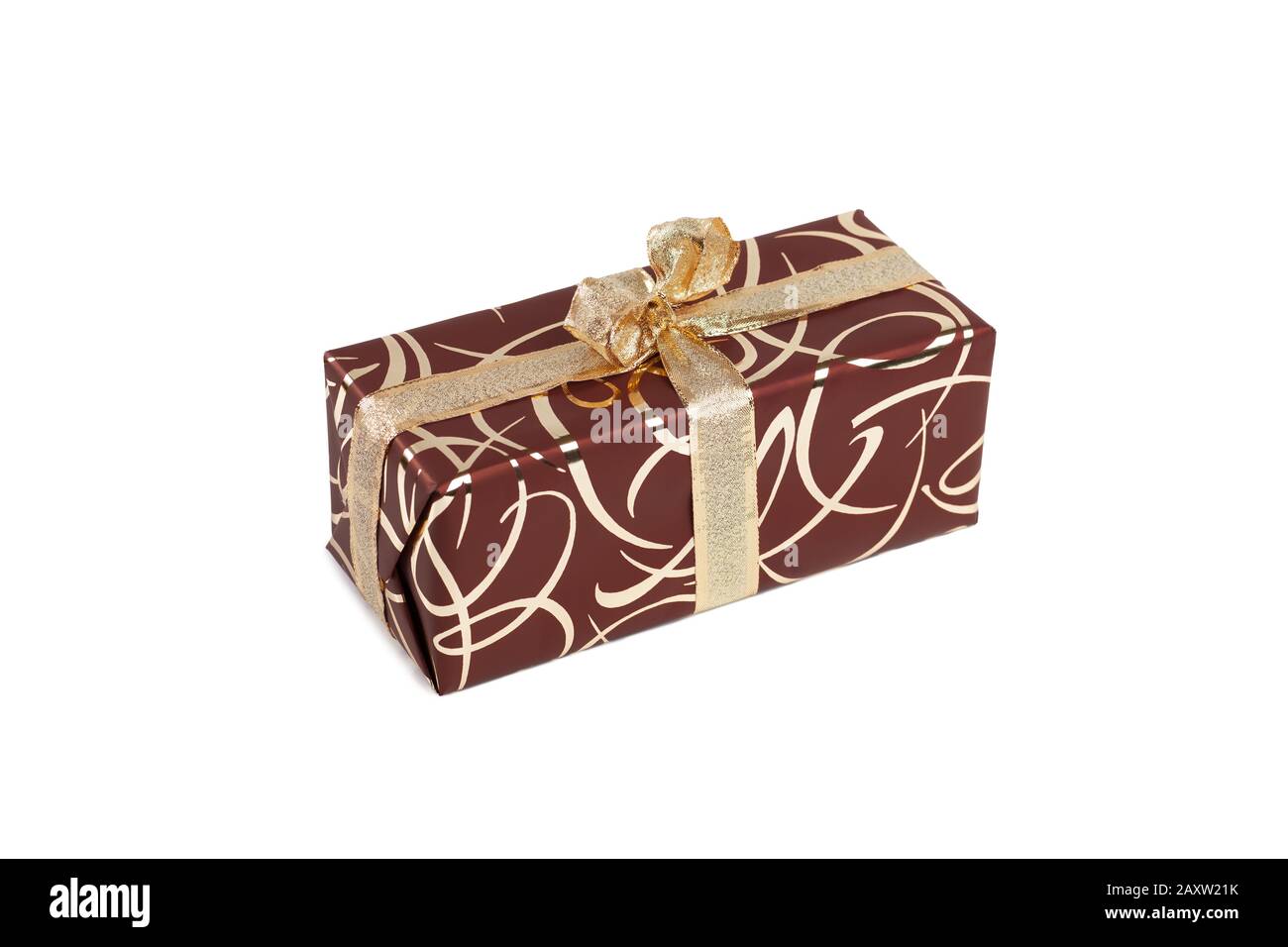 packaged rectangular gift in dark brown packaging with gold bow and gold pattern on a white background Stock Photo