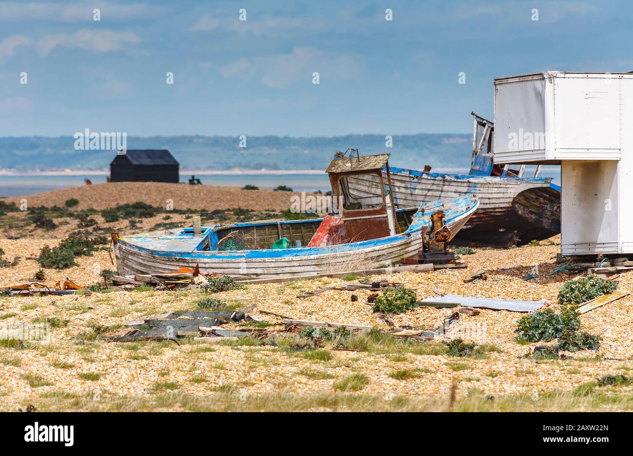 Decaying hull of an old wooden fishing boat abandoned on the shingle ...