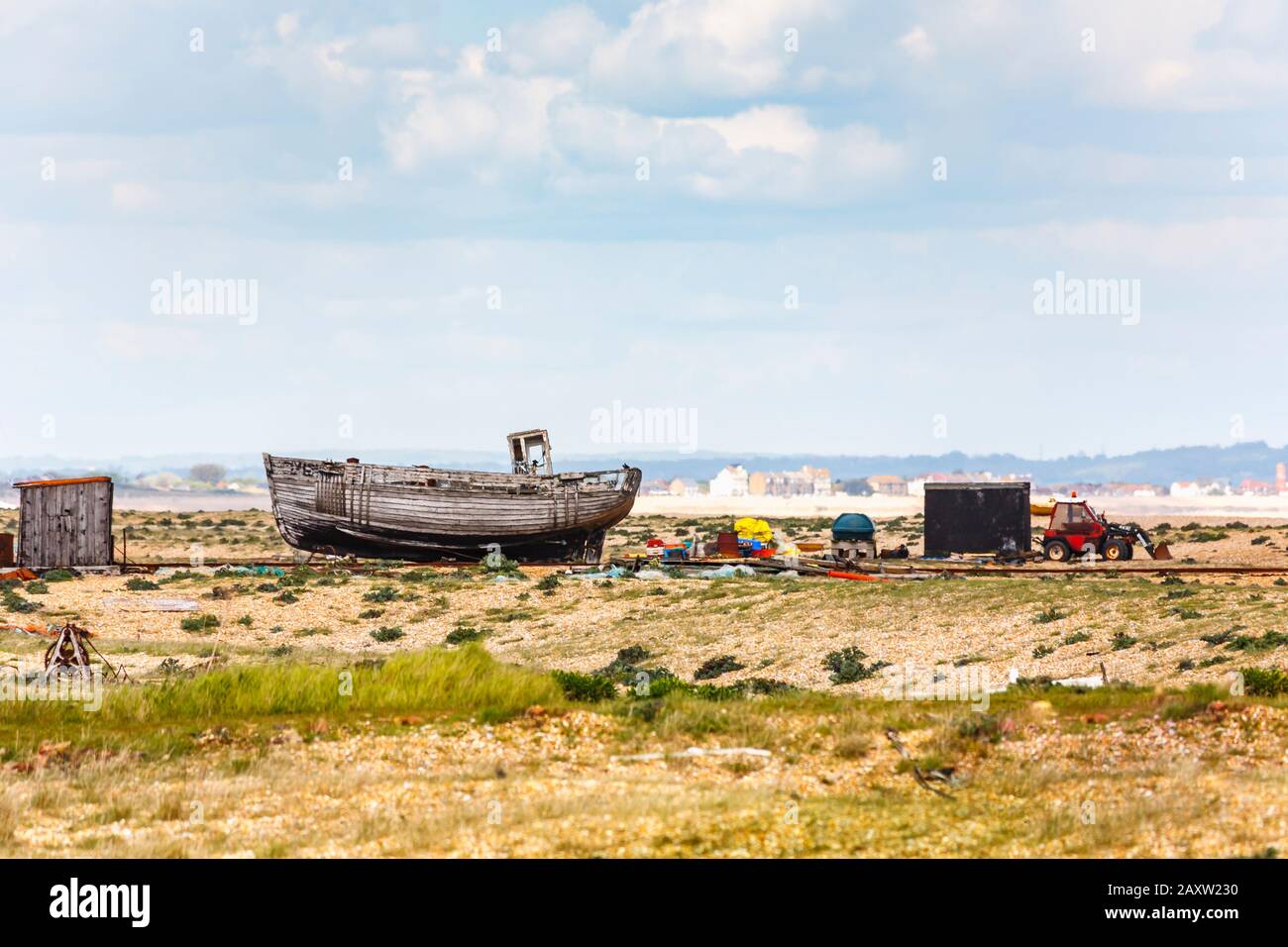 Decaying hull of an old wooden fishing boat abandoned on the shingle ...