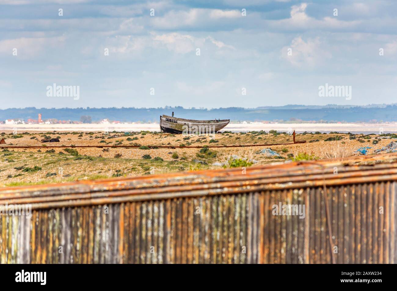 Decaying hull of an old wooden fishing boat abandoned on the shingle ...
