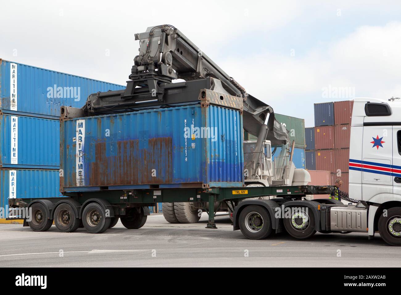 Container being loaded onto truck lorry Stock Photo