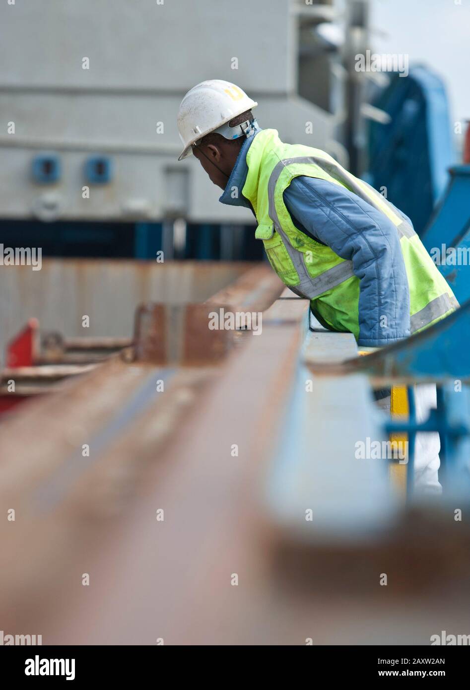 Ship worker inspecting the loading and unloading of cargo Stock Photo