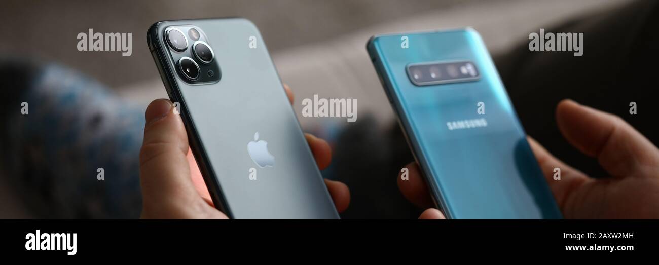 Male hand hold Apple iphone pro and samsung galaxy s 10 Stock Photo - Alamy