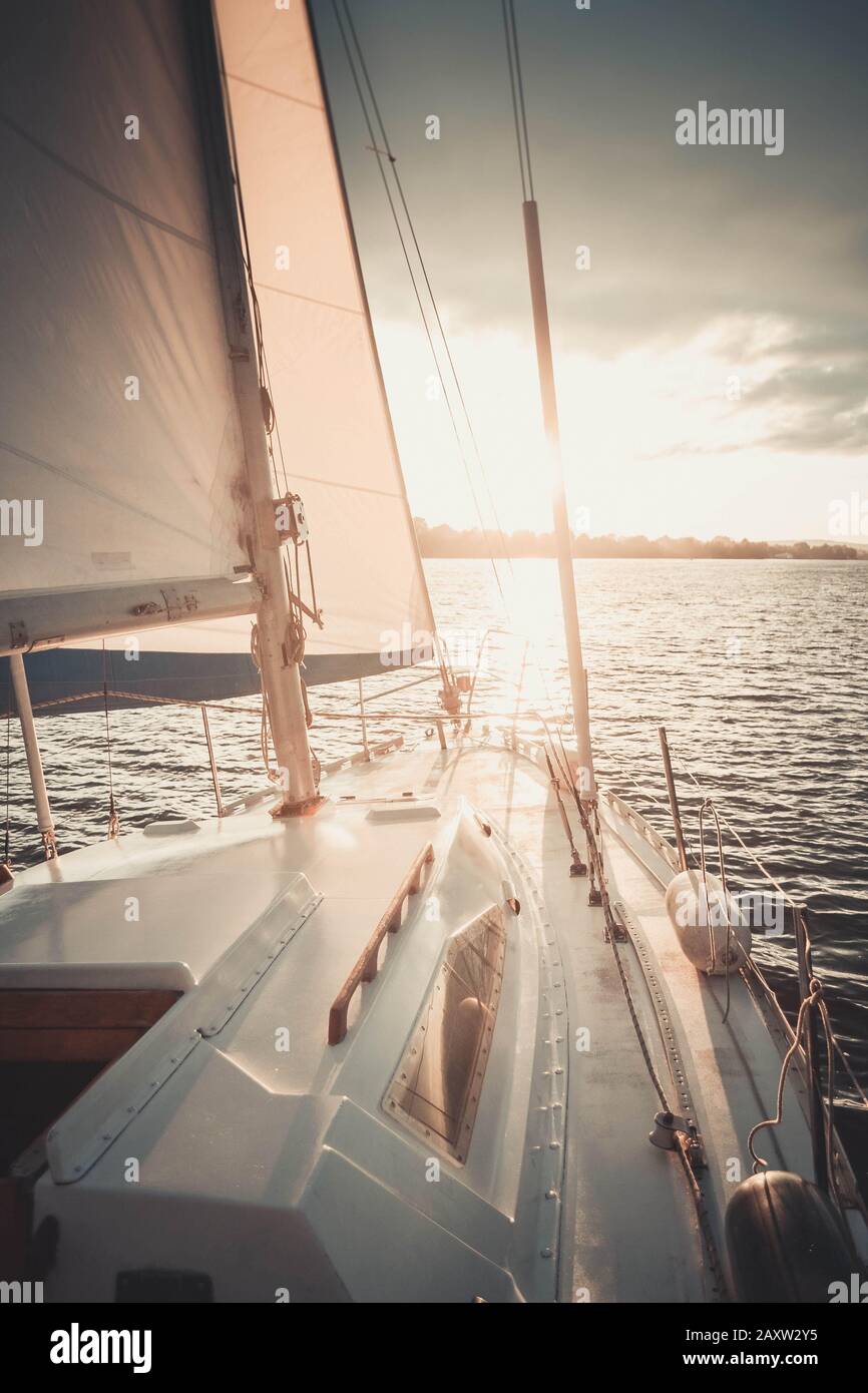 white boat with a sail on the water, filter Stock Photo