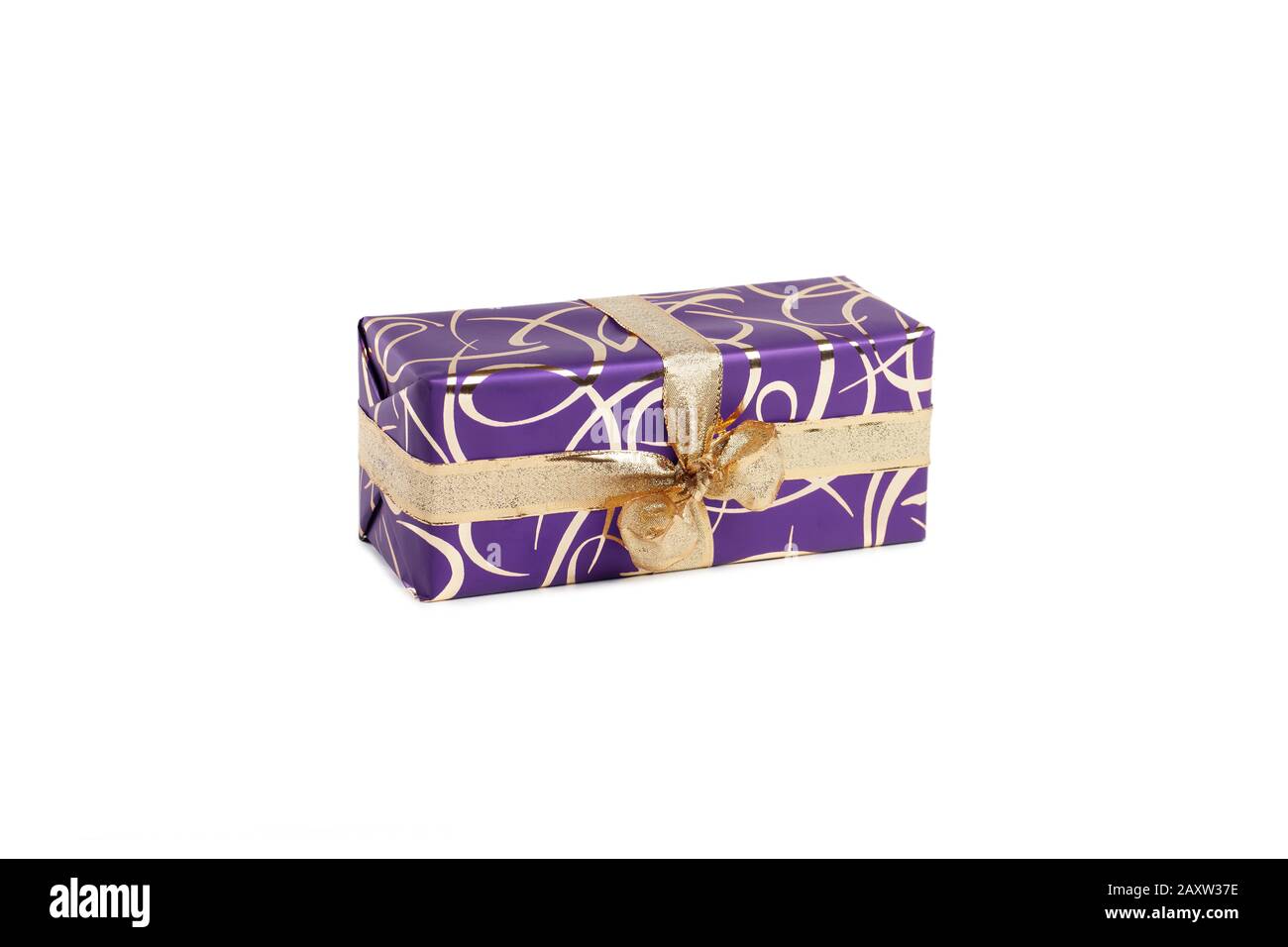 packaged rectangular gift in purple packaging with gold bow and gold pattern on a white background Stock Photo