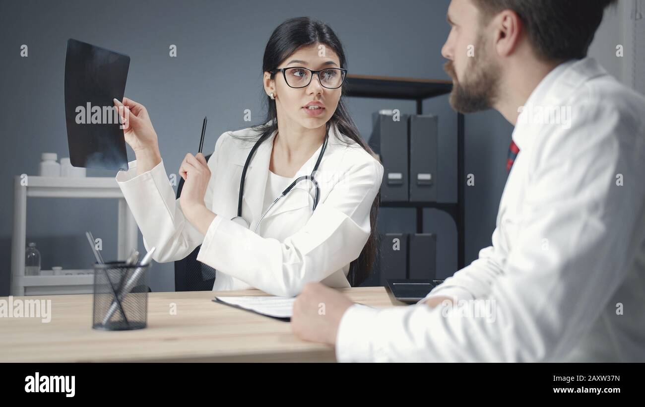 Doctors examining x-ray photograph Stock Photo