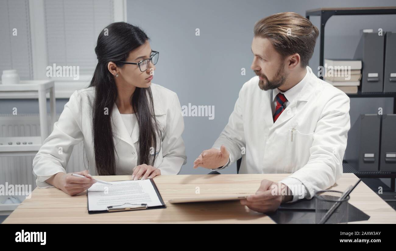 Doctors discussing working moments Stock Photo