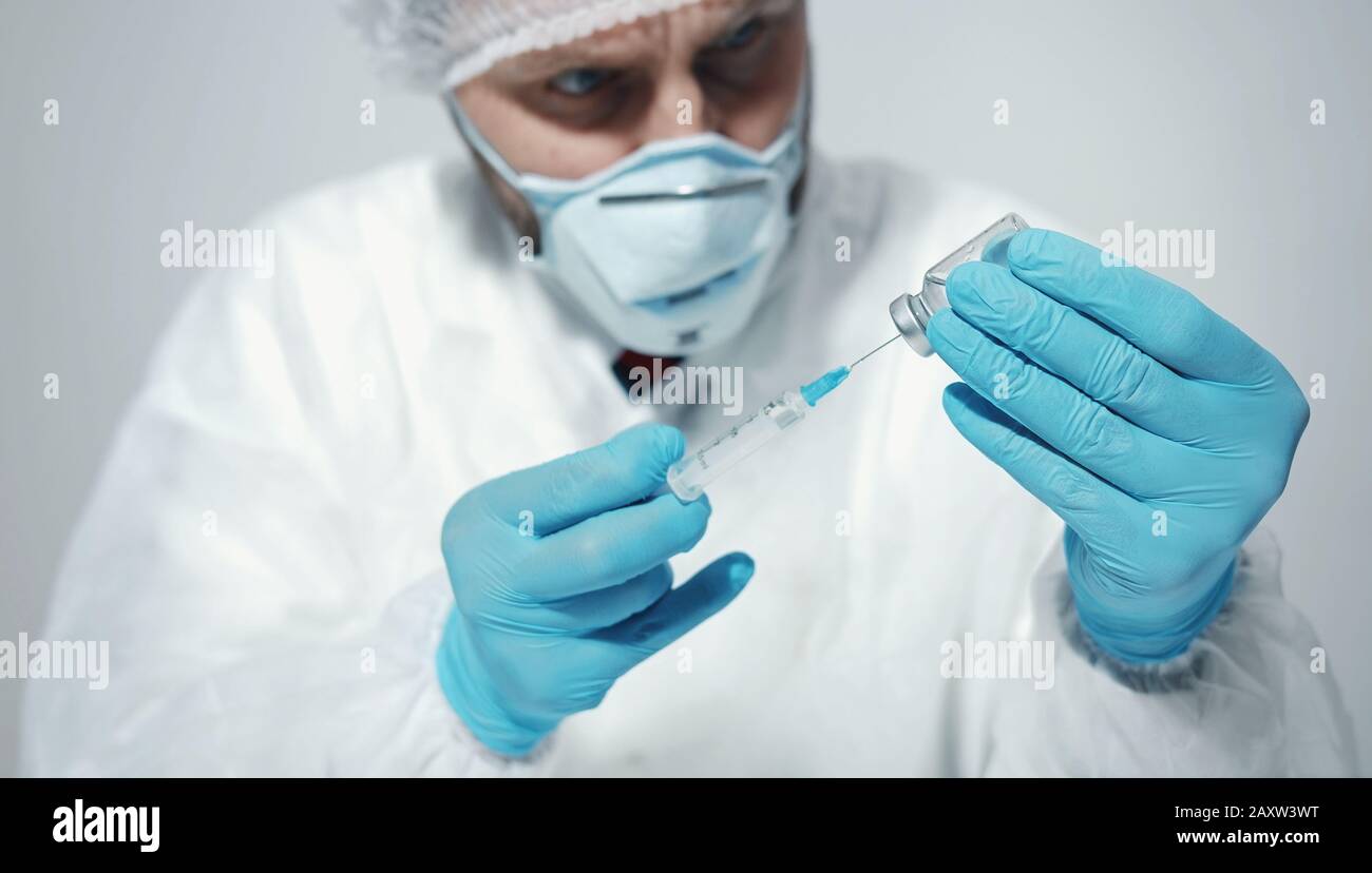 Male doctor preparing syringe Stock Photo