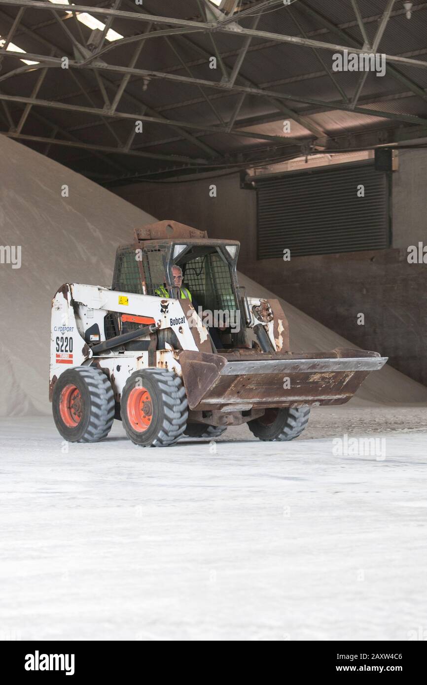 Bob cat small digger moving dry goods Stock Photo