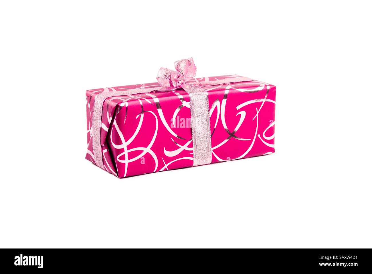 packaged rectangular gift in pink packaging with gold bow and gold pattern on a white background Stock Photo
