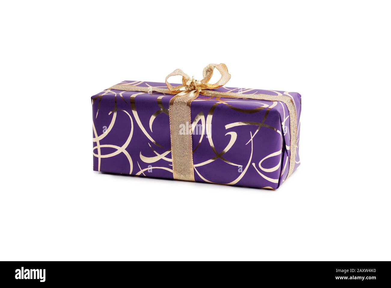 packaged rectangular gift in purple packaging with gold bow and gold pattern on a white background Stock Photo